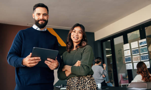 istock Cheerful business colleagues smiling at the camera happily 1359507638