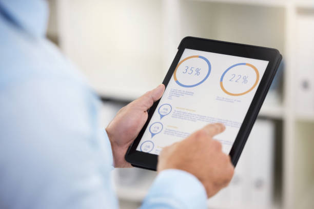 istock Shot of a businessman using his digital tablet 1359510038