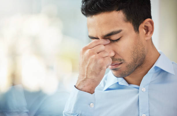 istock Shot of a businessman experiencing a headache at work 1359510054