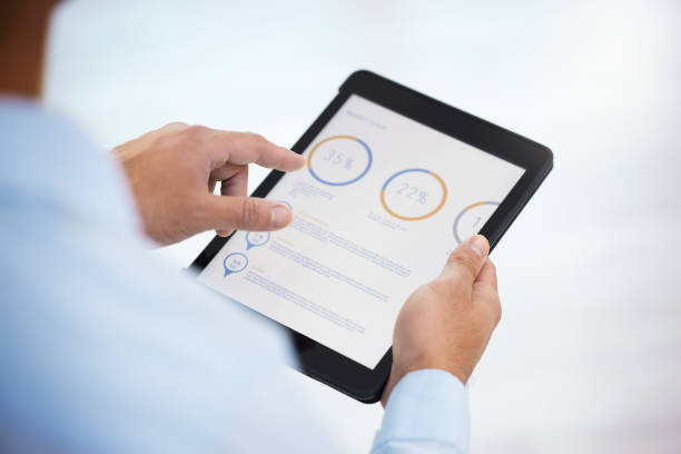 istock Shot of a businessman using his digital tablet 1359510077