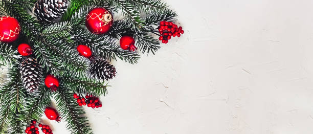 istock Christmas light background, fir branches with red berries. 1359510111
