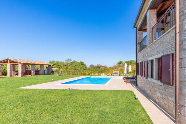 istock Luxurious beautiful modern villa with swimming pool and yard garden 1359510976