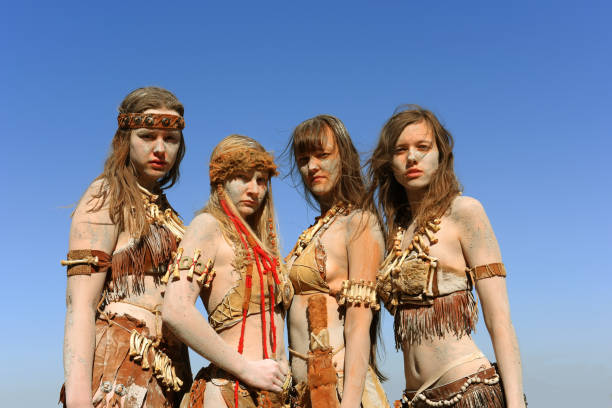 Dirt Covered Neanderthal Women Standing Together
