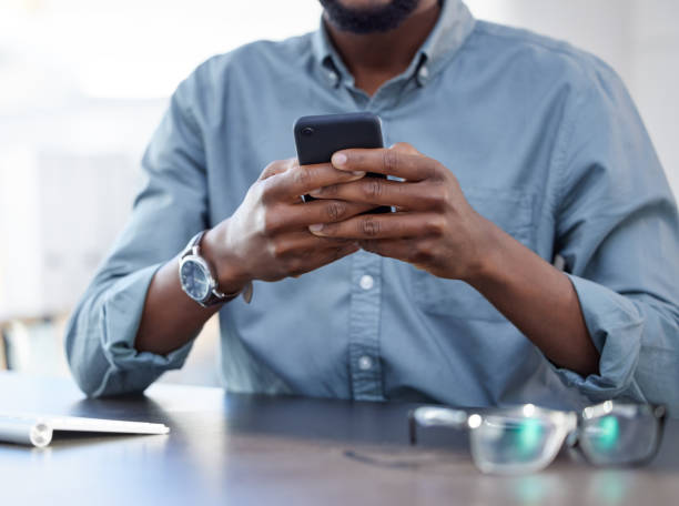 istock Shot of a unrecognizable male using a phone at work in a modern office 1359511467