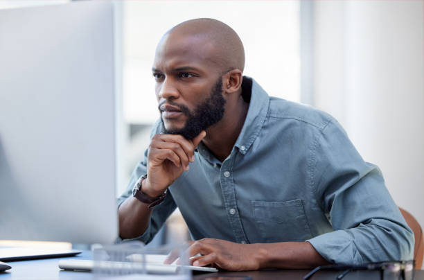 istock Shot of a young businessman using a laptop in a modern office 1359512292