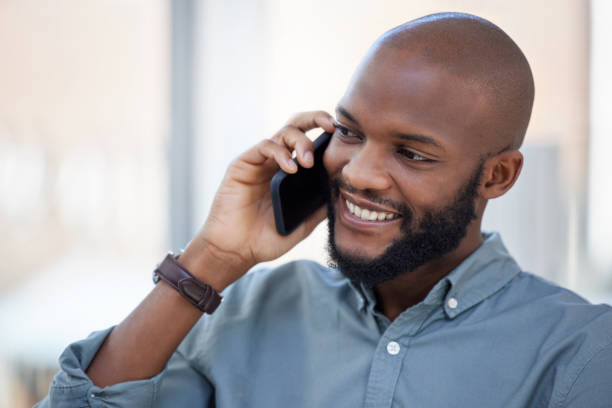 istock Shot of a young businessman using a smartphone in a modern office 1359512298