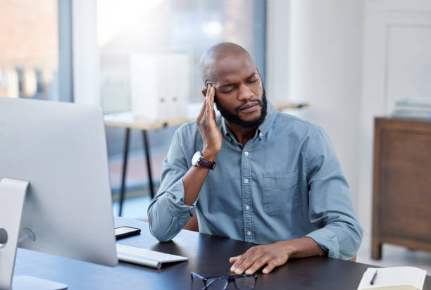istock Shot of a young businessman feeling stressed while working in a modern office 1359512300