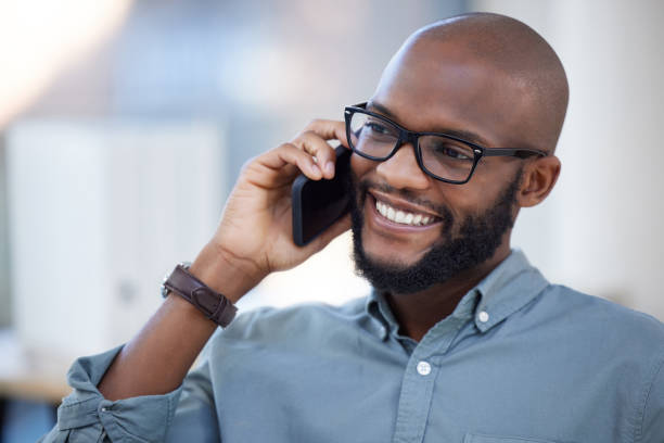 istock Shot of a young businessman using a smartphone in a modern office 1359512305