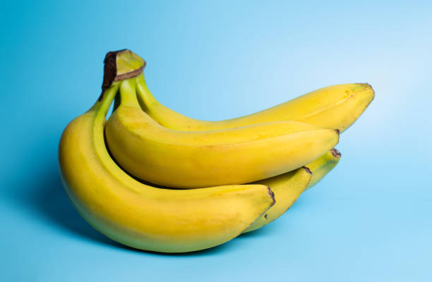 istock A bunch of bananas on a blue background. 1359515855