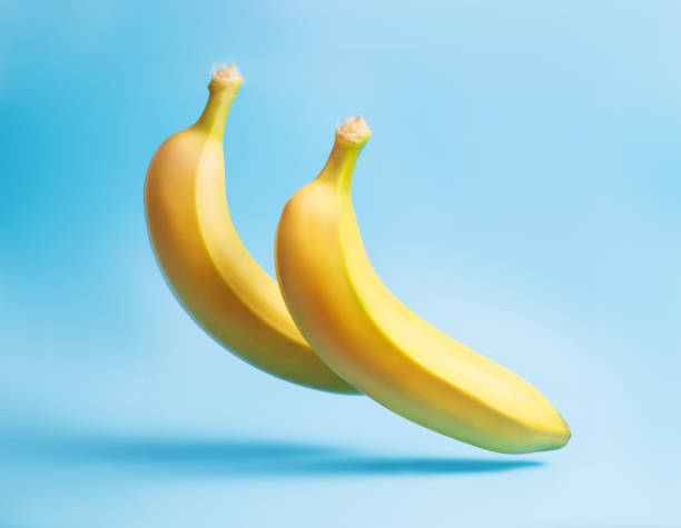 istock Banana levitation. Two yellow bananas on a blue background. 1359515866