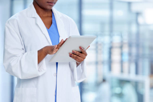 istock Shot of an unrecognizable doctor using a digital tablet at work 1359518709