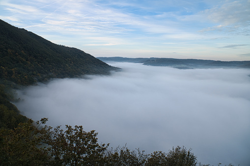 Fog rising on the mountains of the small Saar loop. mystical silence on the river Saar in Saarland.