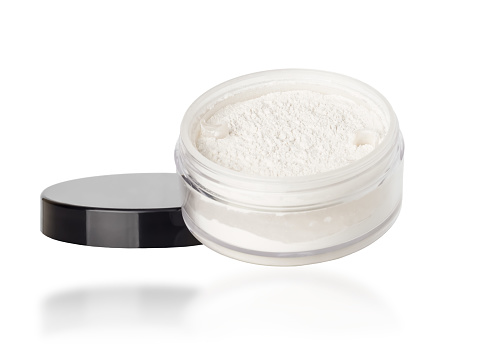 Jar with white mattifying face powder isolated on white background.