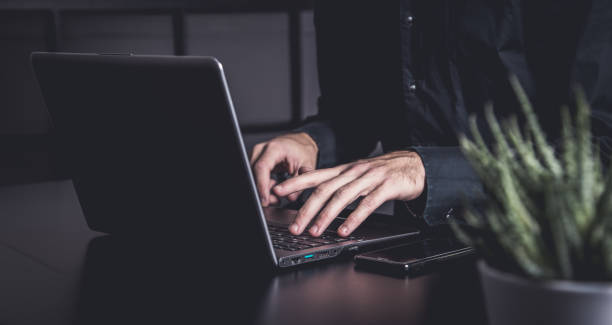 istock Businessman using a smartphone and notebook in a moddy office 1359520759