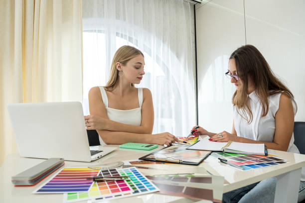 istock two designer discussing at perfect color for home, working with house plan 1359520812