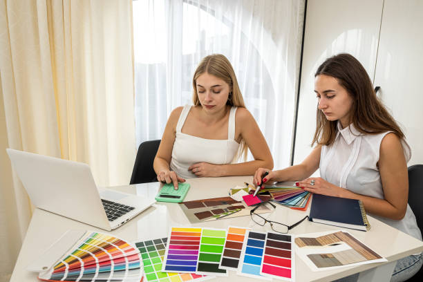 istock two designer discussing at perfect color for home, working with house plan 1359520857