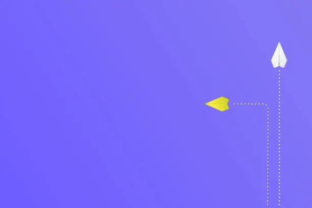 yellow and white paper plane on blue background