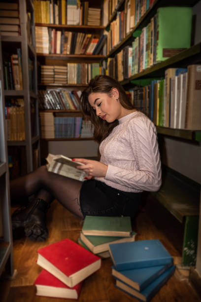 istock student girl reading book at university library 1359521463