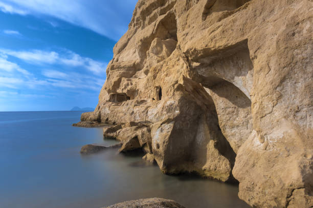 Stunning neolithic era caves on the cliff of Matala beach, Southern Crete, Greece. Used as historically used as living spaces and tombs Stunning neolithic era caves on the cliff of Matala beach, Southern Crete, Greece. Used as historically used as living spaces and tombs stone age stock pictures, royalty-free photos & images