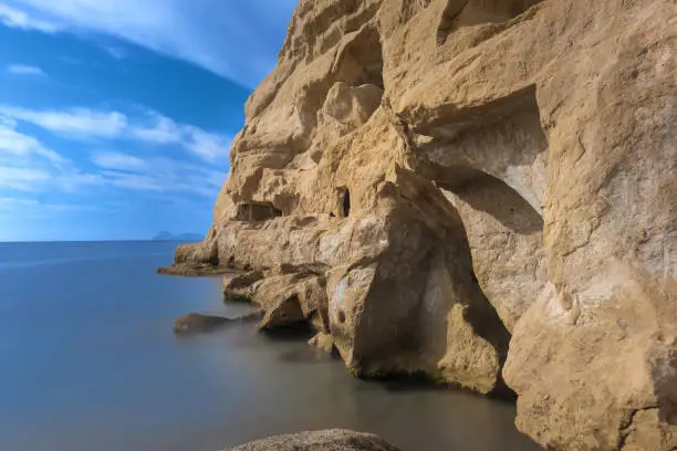 Stunning neolithic era caves on the cliff of Matala beach, Southern Crete, Greece. Used as historically used as living spaces and tombs