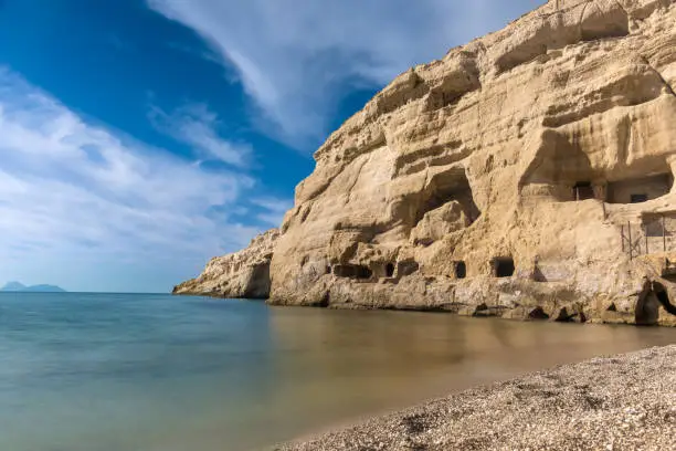 Photo of Stunning neolithic era caves on the cliff of Matala beach, Southern Crete, Greece. Used as historically used as living spaces and tombs