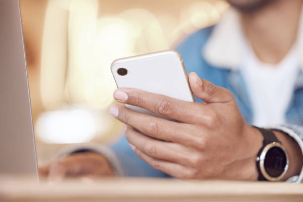 istock Shot of a man using his smartphone while working in a coffee shop 1359522497