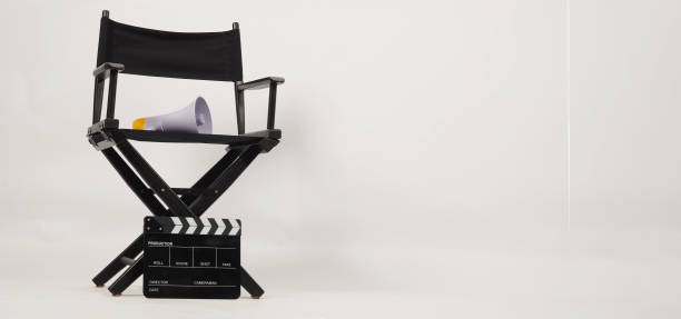 istock Black director chair and Clapper board with yellow megaphone on white background 1359522833