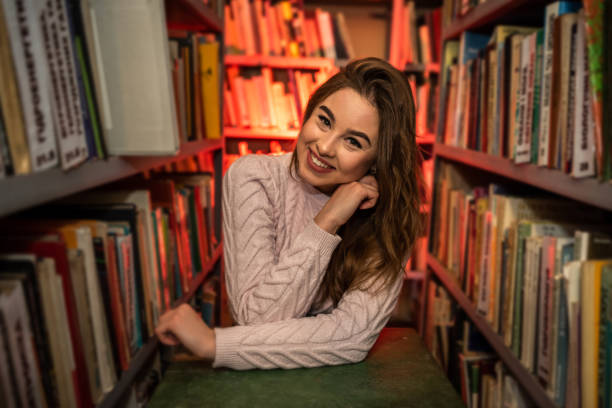 istock female student looking for book in university library 1359522860