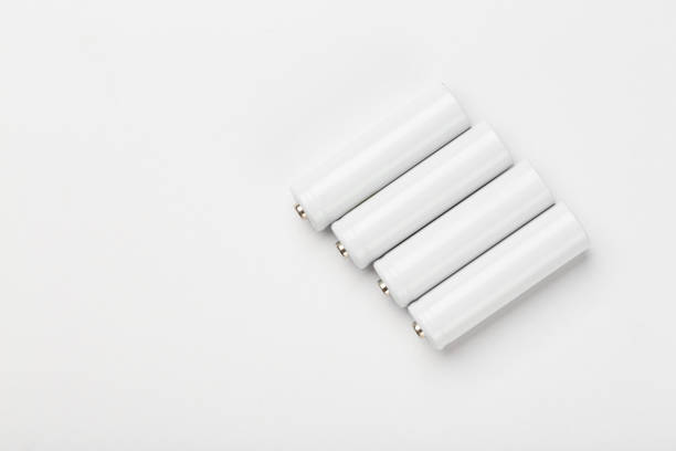 AA size alkaline batteries on a white background. Several batteries in a row. Space for text.
