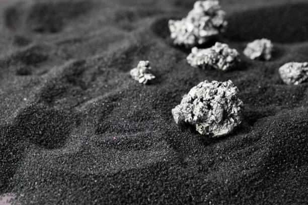 pure silver or platinum from the mine that was unearthed was placed on the black sand. - platina imagens e fotografias de stock