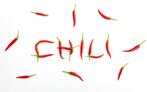 istock Red peppers or chili arranged in letters on a white background 1359527011