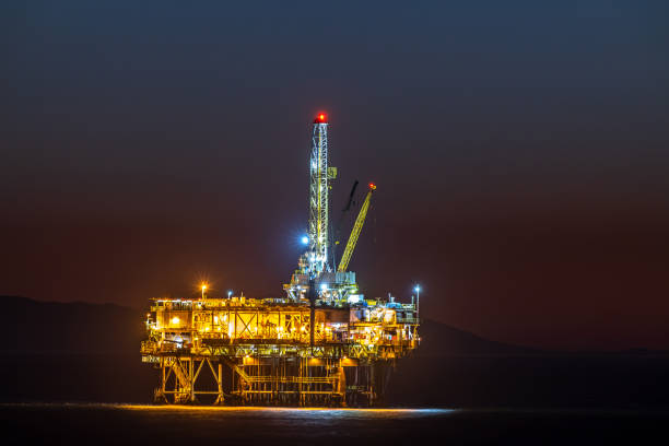 Lighted offshore oil platform at dusk