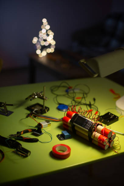 istock bomb making tool and dynamite bomb on the table in the light of the lamp 1359528981