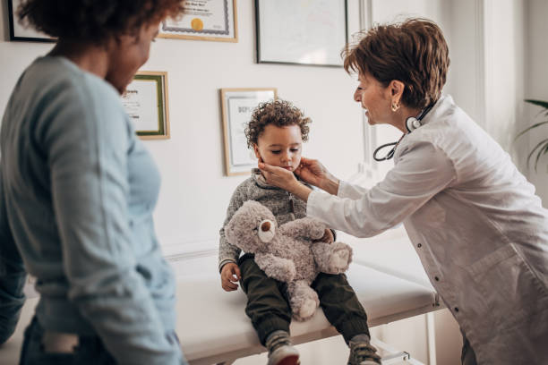 istock Doctor examining little boy 1359528986