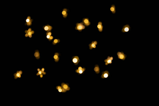 istock Bokeh yellow lights isolated on black background 1359532550