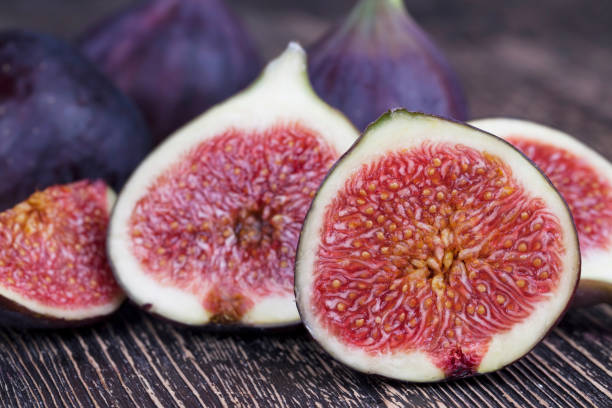 istock ripe purple figs on a wooden table 1359533208