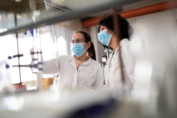Two female chemists analyze medical sample stock photo