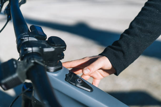 Close up of young woman turning her e-bike on stock photo