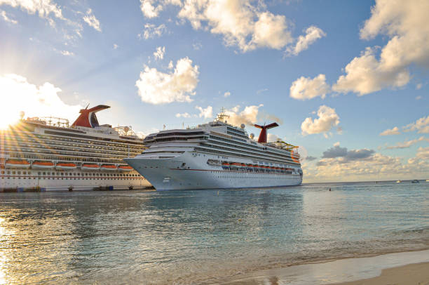 Great Bay beach, Philipsburg, St Maarten. Early morning, and the empty sun loungers await the  passengers from the many docked cruise ships seen in the background.