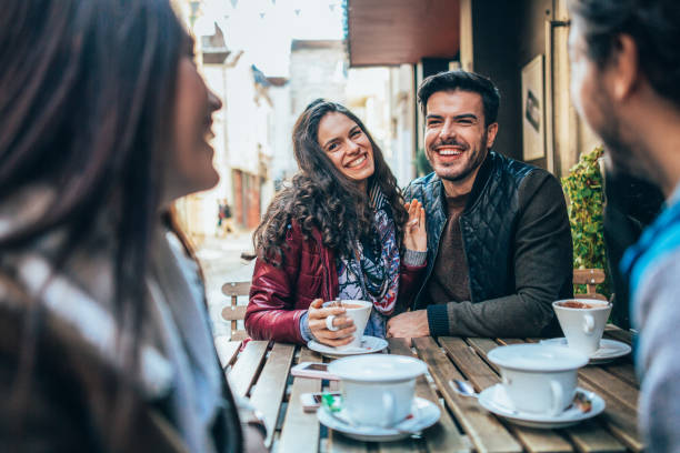 istock Friends talking and laughing in a cafe 1359539550