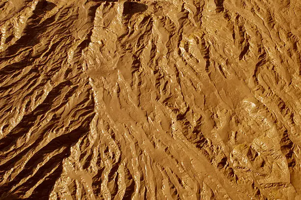 Close up of wet mud, exposed on the River Avon at Bristol, UK, at low tide. Shows a typical terrain-like texture. Could be desert viewed from above, the Martian surface ... anywhere
