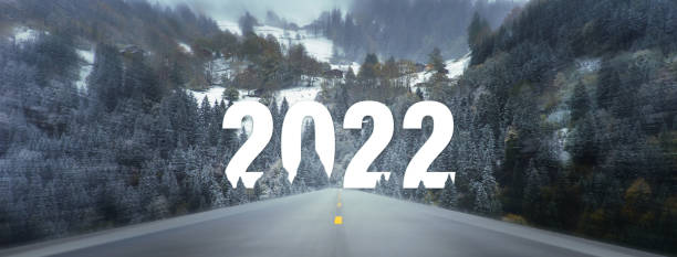 istock Go to the New Year 2022 concept. Empty asphalt road between fields trees. 1359545540
