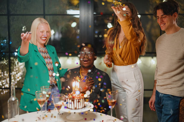 istock Confetti flying around while group of friends celebrating a birthday 1359545895