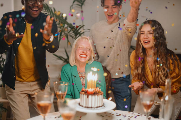 istock Confetti flying around while group of friends celebrating a birthday 1359545958