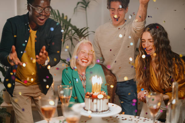 istock Confetti flying around while group of friends celebrating a birthday 1359545960