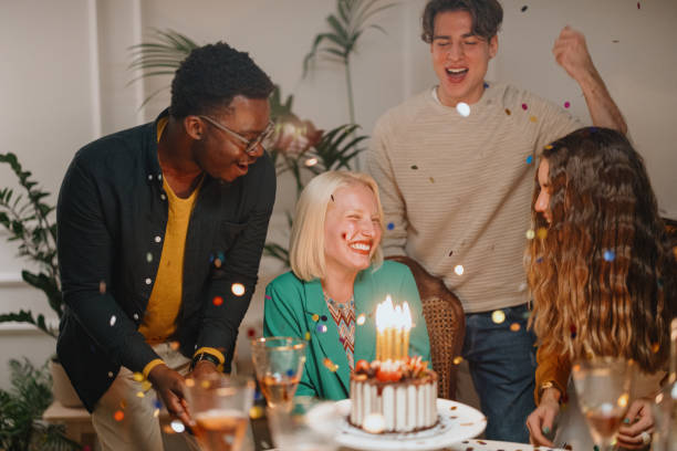istock Confetti flying around while group of friends celebrating a birthday 1359545991