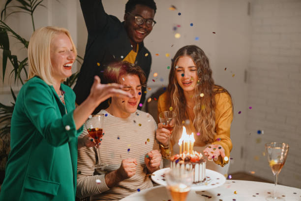 istock Confetti flying around while group of friends celebrating a birthday 1359546024