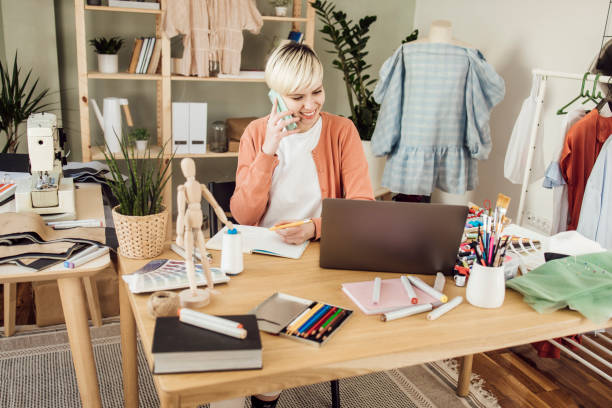 istock Young textile designer taking orders and working on a new collection 1359546879
