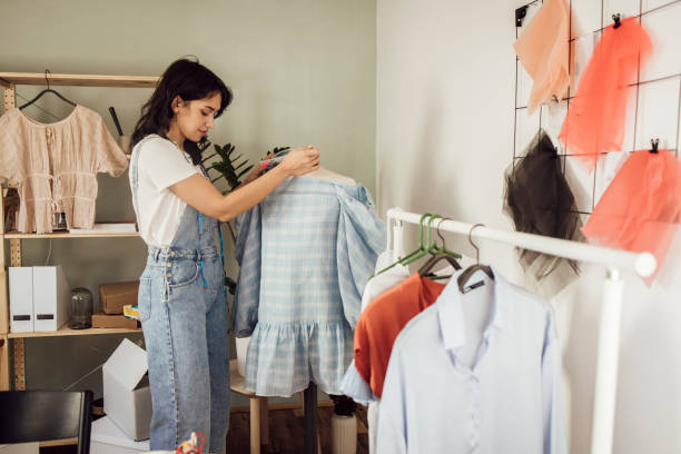 istock Young woman designing and tailoring clothes at her studio 1359546898