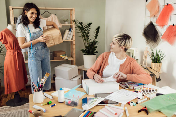 istock Two young clothing designers creating clothes by order 1359546989